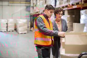 Two people discussing workers' comp claims management for employers