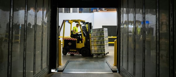 Injury prediction: A man in a forklift is moving boxes of beer on a pallet into a truck