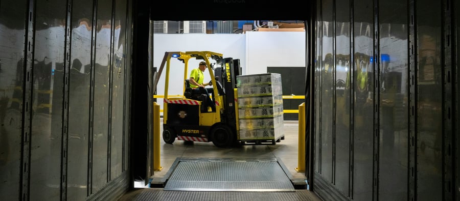 Injury prediction: A man in a forklift is moving boxes of beer on a pallet into a truck