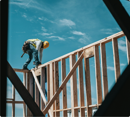 A construction worker framing a build